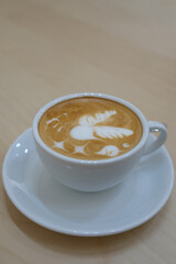 latte art coffee on wood background