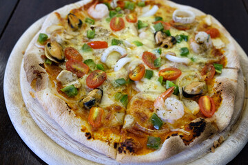 seafood pizza isolate on wood table