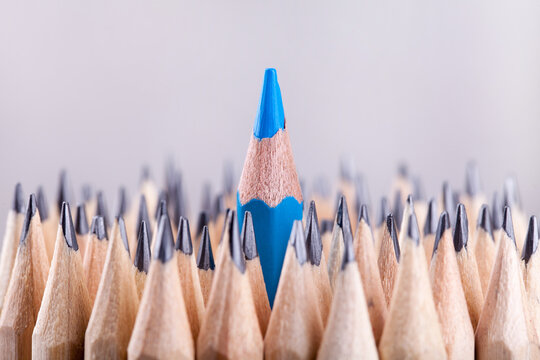 One sharpened blue pencil among many ones