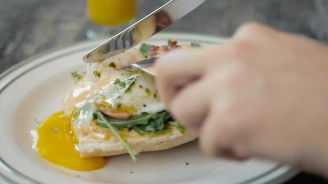 Eggs Benedict with bread and tomato on a plate with becon morning sandwich