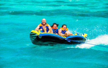 Travel and vacation in El Gouna, Egypt on April. Sea attraction, happy people ride the inflatable...