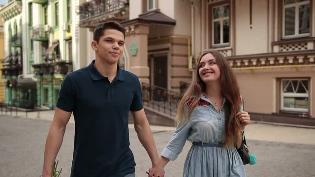 Happy young dating couple in love walking in city