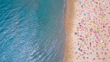 Tropical beach with colorful umbrellas - Top down aerial view