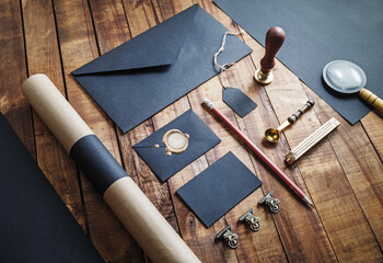 Photo of blank black stationery set on vintage wooden table background. Mock up for branding identity. ID template.