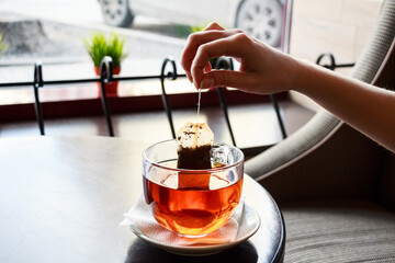 Tea bag put in transparent glass teacup