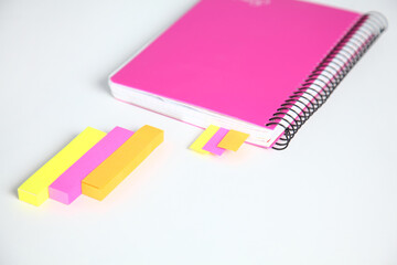 Closeup of white desktop with notepads, pen and other items. Selective focus.