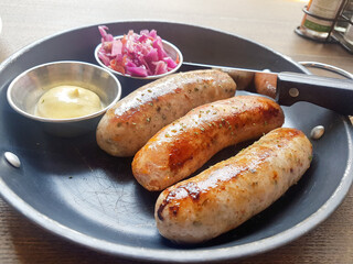 Grilled Sausages Served on Pan with Mayonnaise and Pickles