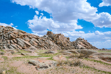 panoramic view of snow-capped mongolian prairie with cloudy sky on background
