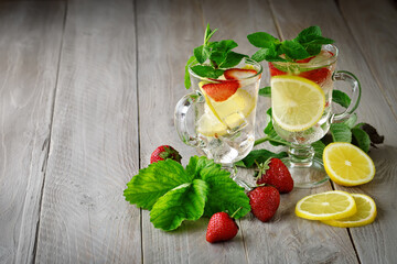 Fresh summer healthy drink with lemon and strawberries with ice.