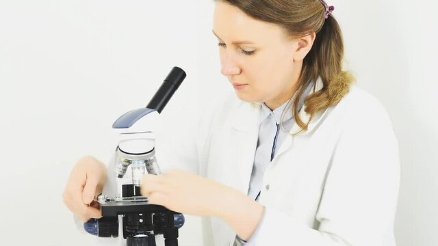 Scientist using microscope in laboratory. 
