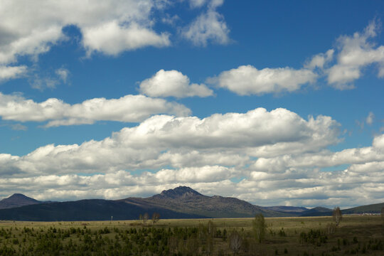 landscape with cloudy sky and the Ural mountains in Bashkiria, Russia
