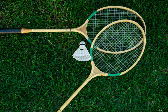 Badminton rackets and shuttlecocks isolated on green, top view, Fresh lawn
