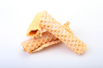 Homemade wafer rolls with powdered sugar isolated on white background