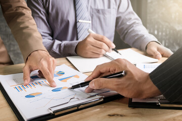 business executives discussing documents and ideas at meeting in a workplace