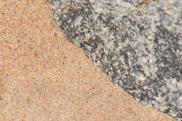 An abstract background of a sea sand and rock shapes. Shallow depth of field.