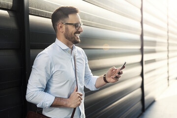 Smiling businessman using phone