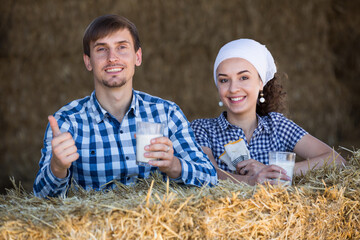 man and woman in hay with milk