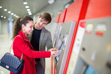 Passengers buying subway ticket.