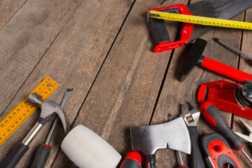 Assorted work tools on wood background