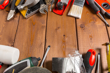 Assorted work tools on wood background