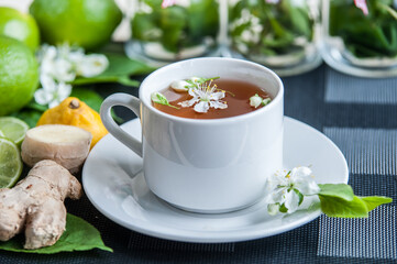 White cup with tea. Green, black, herbal, jasmine tea with lemon and ginger.