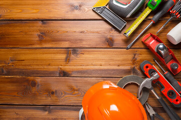 Assorted work tools on wood background