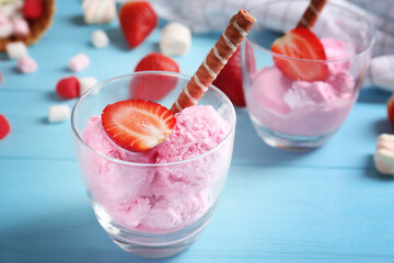 Delicious ice-cream with strawberry in glasses on table