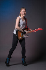 Fototapeta premium Girl with guitar at the rehearsal before the performance