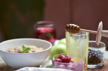 The concept of a healthy Breakfast. Oatmeal with berries, apples and honey.