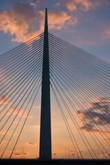 Silhouette of a huge cable bridge over Sava river at sunset in Belgrade, Serbia