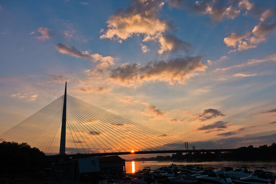 Silhouette of a huge cable bridge over Sava river at sunset in Belgrade, Serbia