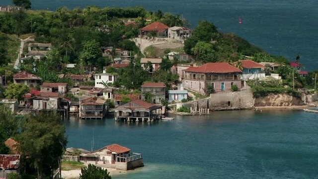 Close shot of the old looking houses on the small island in the Bay of Santiago de Cuba
