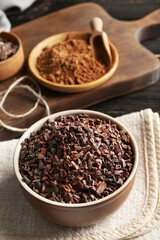 Bowl with cocoa nibs on table