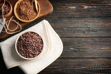 Bowl with cocoa nibs on table
