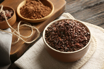 Bowl with cocoa nibs on table
