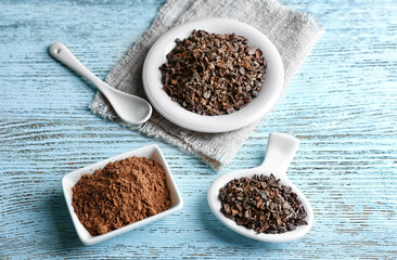 Composition with cocoa nibs and powder on wooden table