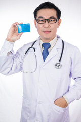 Asian Chinese male doctor holding credit card with stethoscope