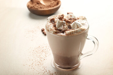Cup of tasty cocoa drink with marshmallow on light background