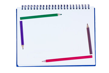 blank notebook with metal spiral and four crayons
