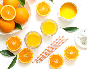 Orange juice and oranges isolated on white background top view.