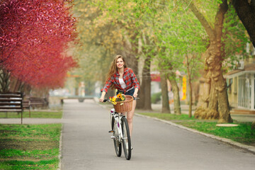 Young smiling girl cycling in park