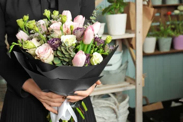 Foto auf Acrylglas Blumenladen Woman holding beautiful blooming bouquet of flowers in shop