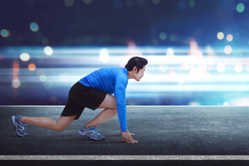 Fototapeta premium Handsome asian man runner with ready position for running
