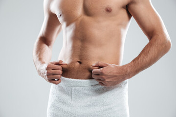 Cropped image of young man dressed in towel