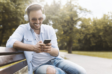 Fototapeta premium Man listening music in public park