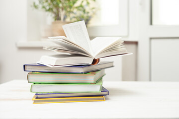 A stack of books on a white table