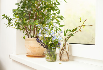 A bouquet of wild flowers on the windowsill