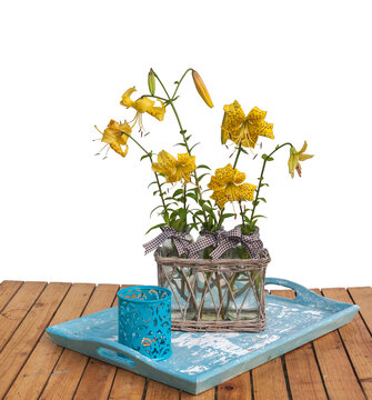 Bouquet of yellow lilies Citronella on blue tray  on a white background
