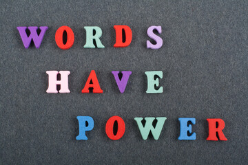 WORDS HAVE POWER word on black board background composed from colorful abc alphabet block wooden letters, copy space for ad text. Learning english concept.