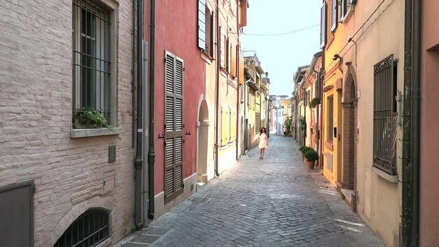 smiling lady walking in Italian hamlet